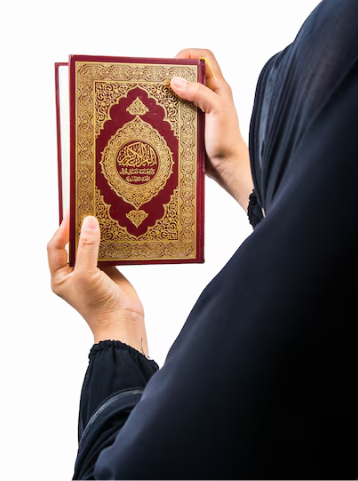 A Muslim man holding the Holy Quran with both hands before recitation.